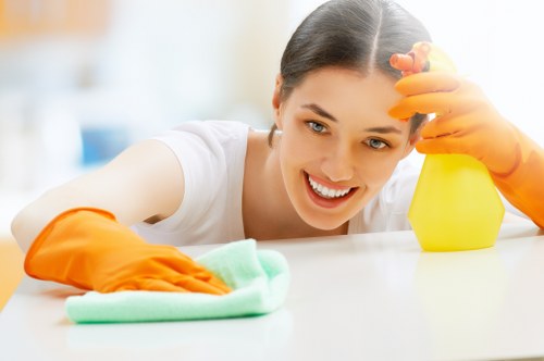 Staff member managing carpet cleaning equipment and maintaining a safe workspace