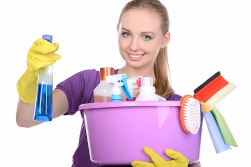 Professional carpet cleaners working safely with PPE and protective procedures